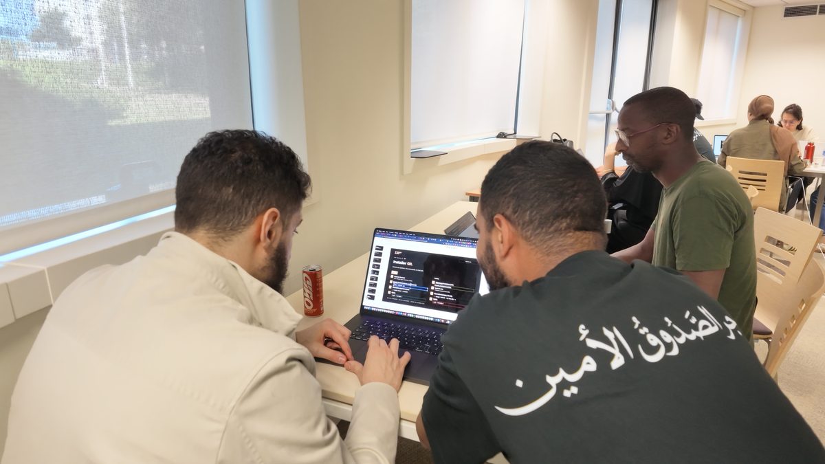 Deux membres du Collectif Tariqa Pro travaillant ensemble pendant un bootcamp